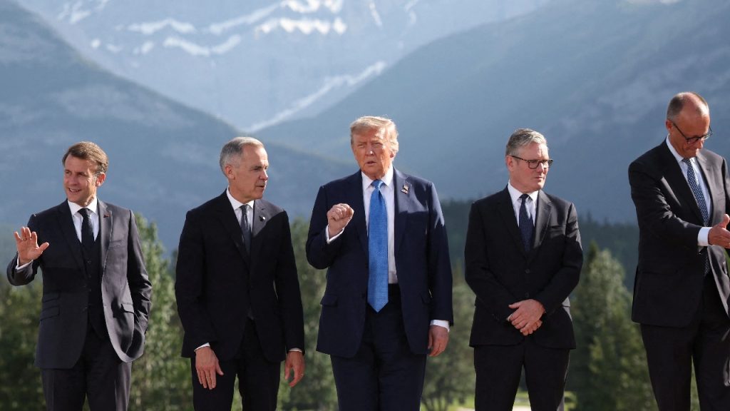 A line of European leaders and Donald Trump walking together outdoors, with Trump in the center