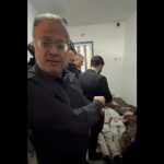 Israeli National Security Minister Itamar Ben-Gvir standing inside a prison facility with several Palestinian detainees lying on the floor in the background.