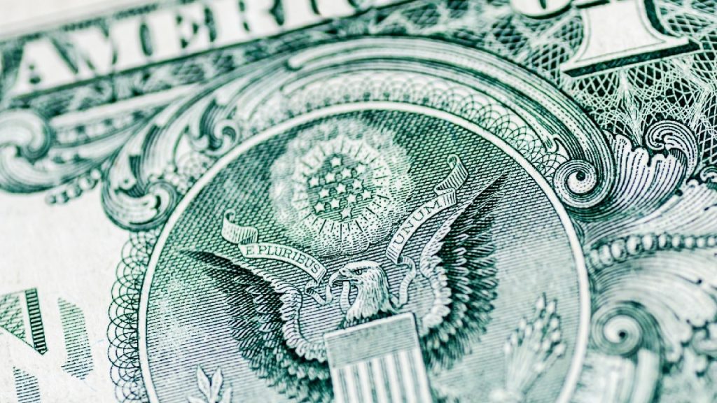 Extreme close-up of the back of a US one-dollar bill focusing on the Great Seal.