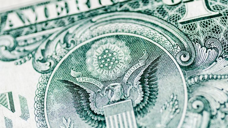 Extreme close-up of the back of a US one-dollar bill focusing on the Great Seal.