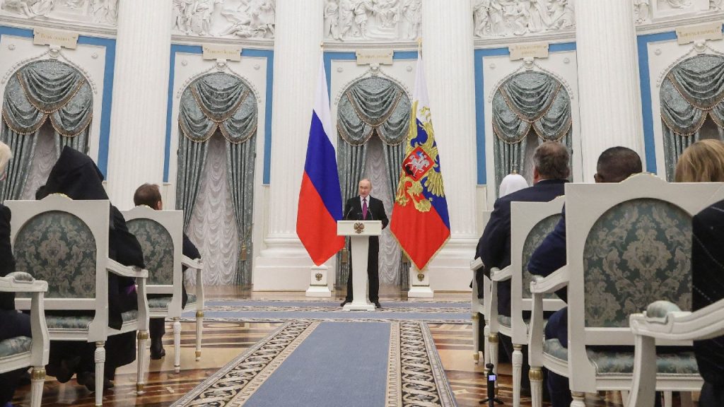 Russian President Vladimir Putin speaking at a press conference, with a backdrop focused on strategic defense and nuclear deterrence.
