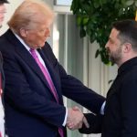 Donald Trump shaking hands with Volodymyr Zelenskyy in front of U.S. and Ukrainian flags