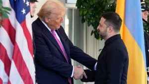 Donald Trump shaking hands with Volodymyr Zelenskyy in front of U.S. and Ukrainian flags