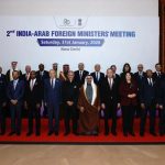 A group of over twenty diplomats and officials in suits and traditional Arab attire standing for a formal group photo on a red carpet in front of a large white banner that reads "2nd INDIA-ARAB FOREIGN MINISTERS' MEETING, Saturday, 31st January, 2026, New Delhi."