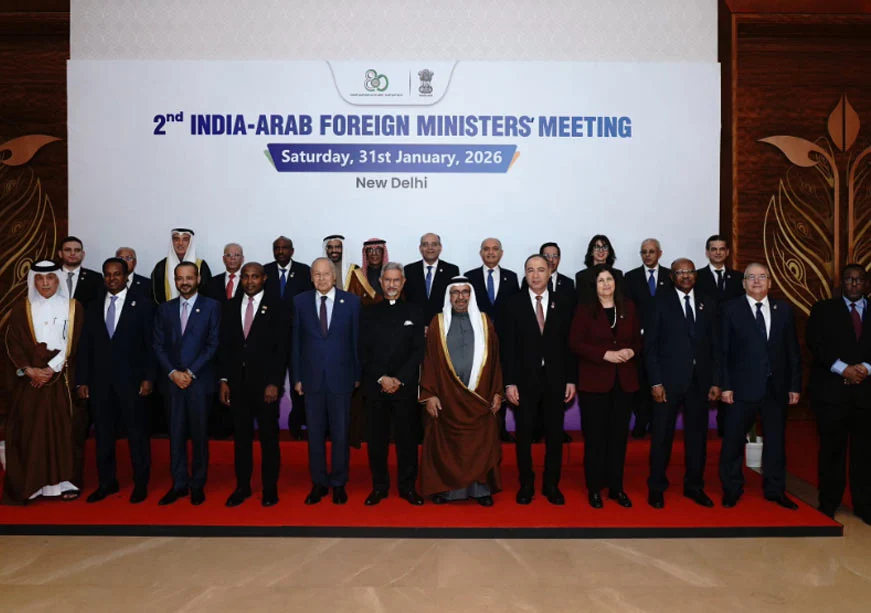 A group of over twenty diplomats and officials in suits and traditional Arab attire standing for a formal group photo on a red carpet in front of a large white banner that reads "2nd INDIA-ARAB FOREIGN MINISTERS' MEETING, Saturday, 31st January, 2026, New Delhi."