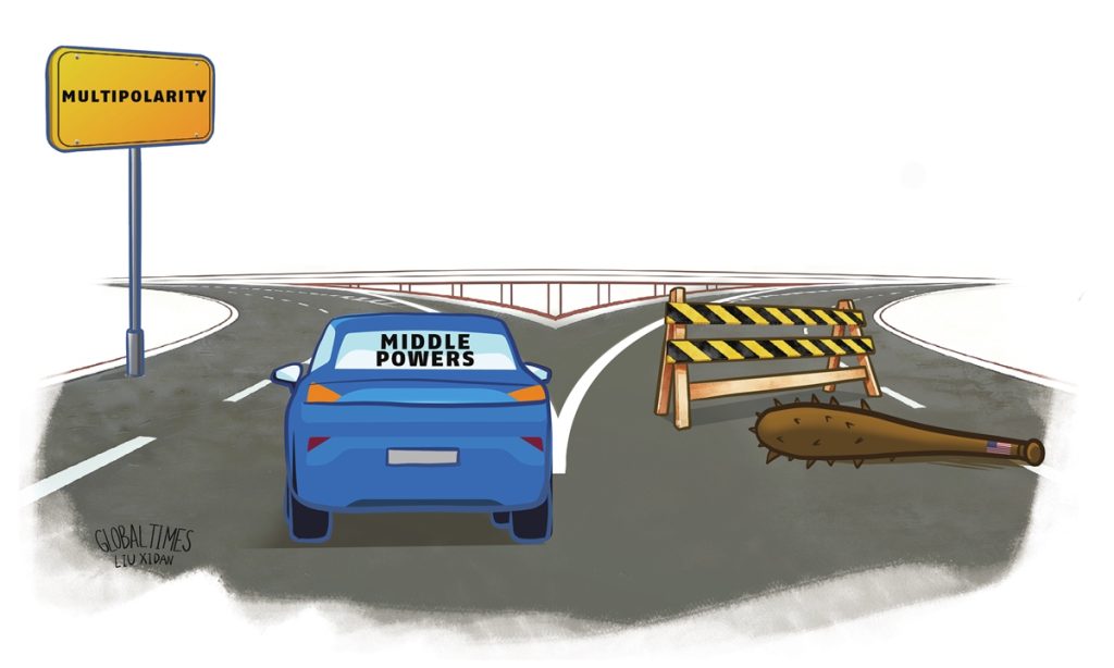 A political cartoon showing a blue car labeled "MIDDLE POWERS" at a fork in the road, choosing the left path toward a yellow sign that says "MULTIPOLARITY" while the right path is blocked by a wooden barrier and a spiked club with a US flag.