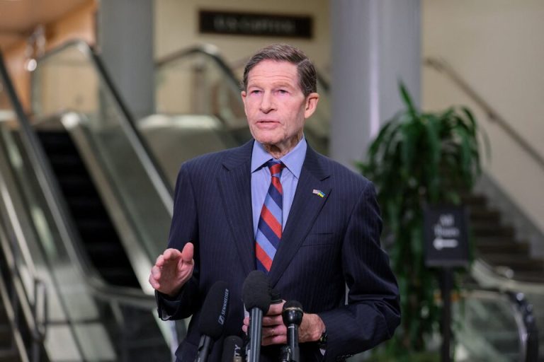 Senator Richard Blumenthal speaking at a press conference with US-Ukraine flag pin.