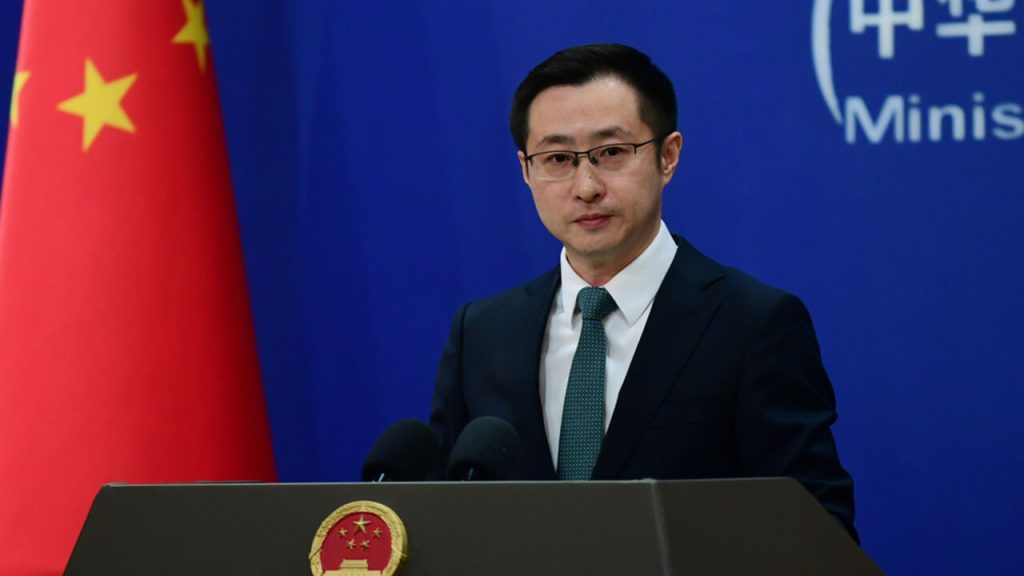 Chinese Foreign Ministry spokesperson Lin Jian speaking at a press conference podium with the Chinese flag in the background.