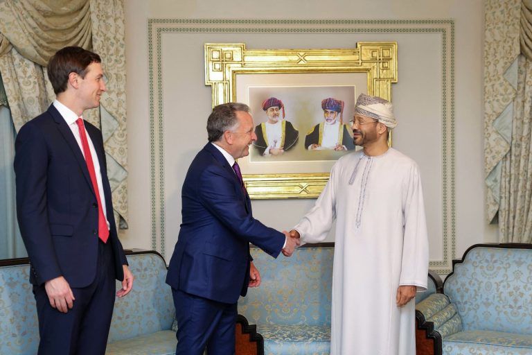 Alt Text Jared Kushner watching a handshake between a Western official and an Omani diplomat.