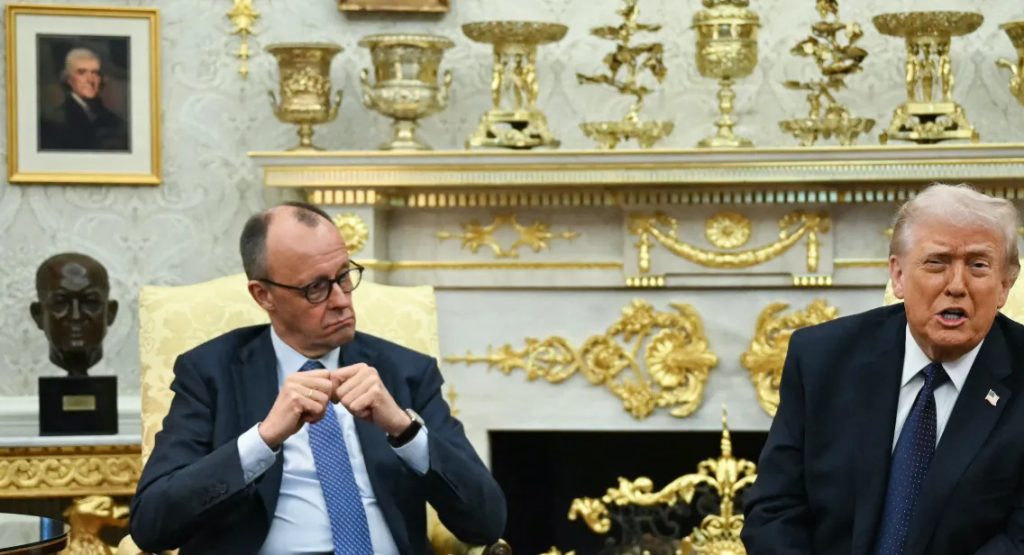 German politician Friedrich Merz and Donald Trump sitting in an ornate room during a meeting.