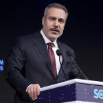 Turkish Foreign Minister Hakan Fidan speaking at the Stratcom Summit '26 podium.