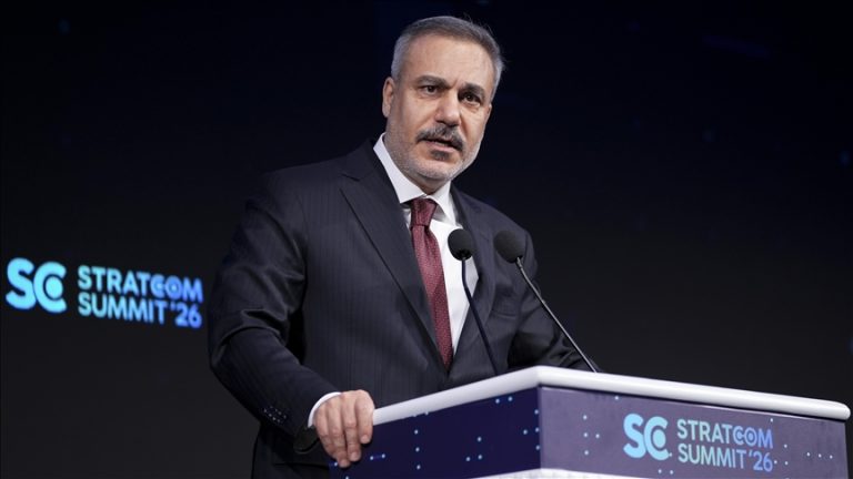 Turkish Foreign Minister Hakan Fidan speaking at the Stratcom Summit '26 podium.
