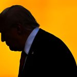 Silhouette of Donald Trump in profile against a solid bright orange background.