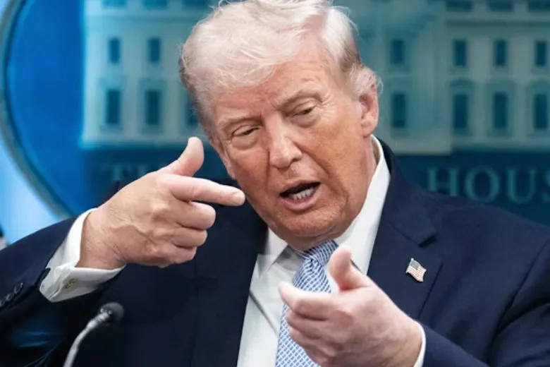 Donald Trump speaking at a podium with the White House logo in the background.