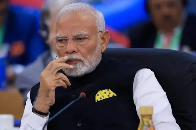 Close-up portrait of Indian Prime Minister Narendra Modi looking contemplative during a meeting.