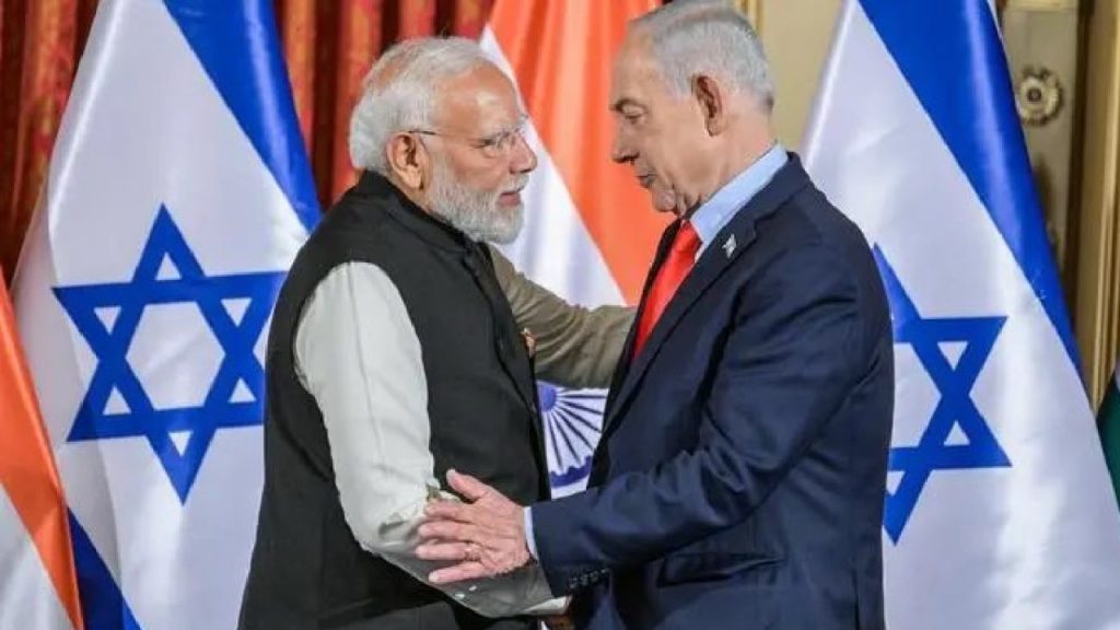 Indian Prime Minister Narendra Modi and Israeli Prime Minister Benjamin Netanyahu shaking hands in front of national flags.