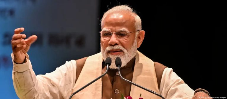 Indian Prime Minister Narendra Modi speaking at a podium during an official event.