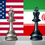 Two chess kings, one silver and one black, standing on a chessboard with the blurred flags of the United States and Iran in the background.