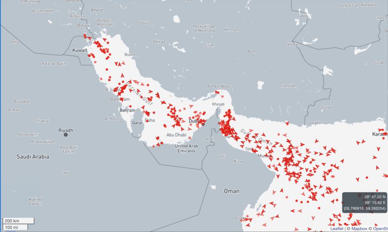 A digital maritime map showing heavy shipping traffic and vessel icons in the Strait of Hormuz.