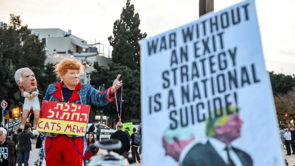 Protesters in an urban setting holding a sign that reads "War without an exit strategy is a national suicide!"