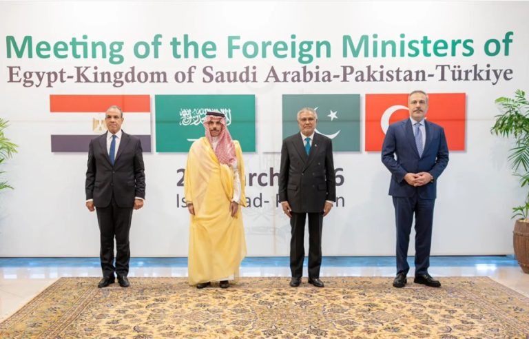Foreign Ministers of Egypt, Saudi Arabia, Pakistan, and Türkiye standing together in front of a joint summit banner.