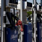 Close-up of several blue and white gas station fuel pumps.