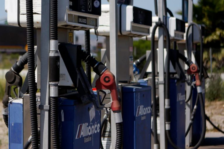 Close-up of several blue and white gas station fuel pumps.