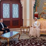 A diplomatic meeting between an Iranian official and an Omani leader in a grand palace room.