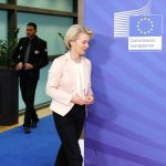 Ursula von der Leyen and Isaac Herzog walking together at the European Commission building in Brussels.
