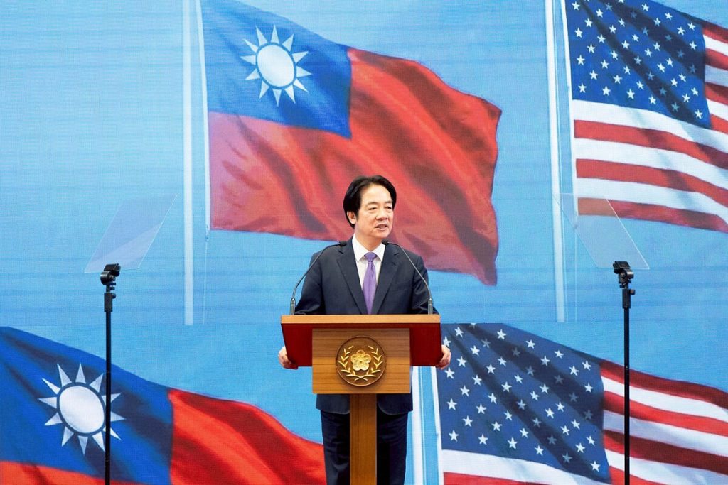 President Lai Ching-te of Taiwan speaking at a podium with Taiwanese and American flags in the background.