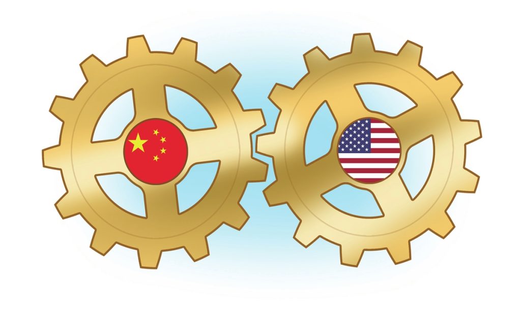 Two gold interlocking gears featuring the national flags of China and the United States.