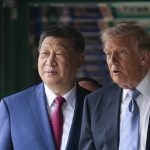 Chinese President Xi Jinping and US President Donald Trump walking together indoors during a diplomatic summit in Beijing.