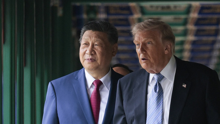 Chinese President Xi Jinping and US President Donald Trump walking together indoors during a diplomatic summit in Beijing.