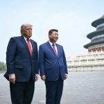 Donald Trump and Chinese President Xi Jinping standing side by side in a large stone courtyard with the Temple of Heaven in Beijing visible in the background.