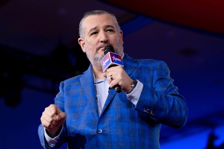 Ted Cruz speaking into a microphone at a CPAC event.