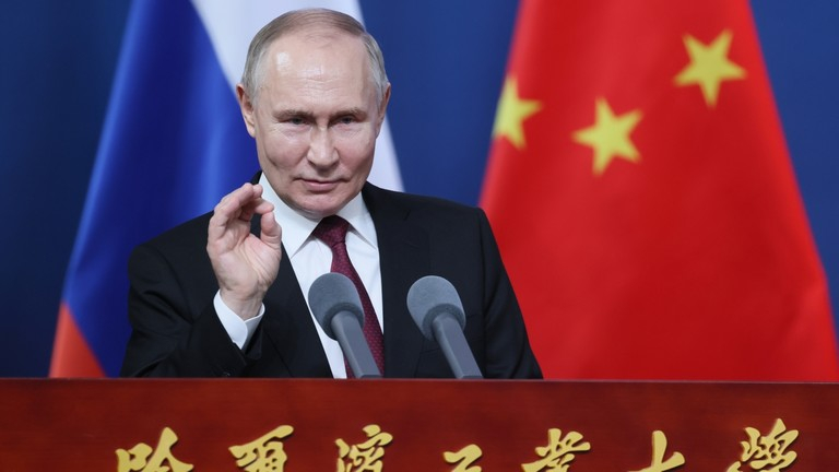 Vladimir Putin speaking at a podium with Russian and Chinese flags in the background.
