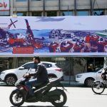 A large street billboard in Iran depicting military failures and naval captures.