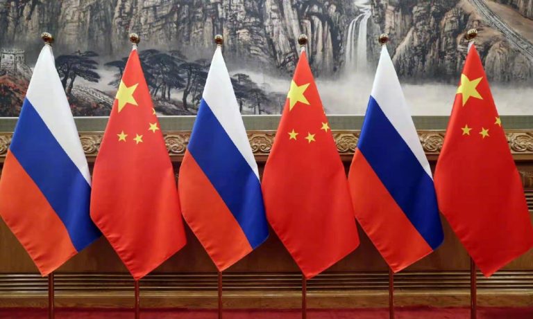Alternating flags of China and Russia displayed at a summit.
