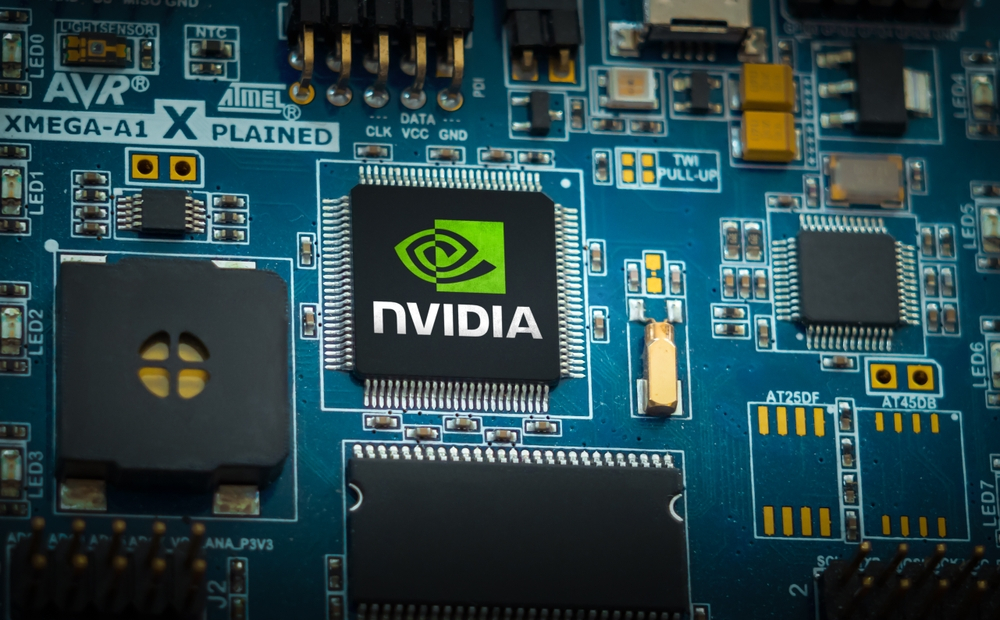A close-up view of a high-performance NVIDIA computer chip mounted on a complex blue circuit board.