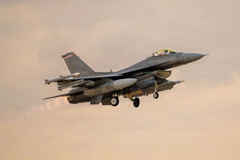 A U.S. F-16 fighter jet in flight, representing military power and global base presence.