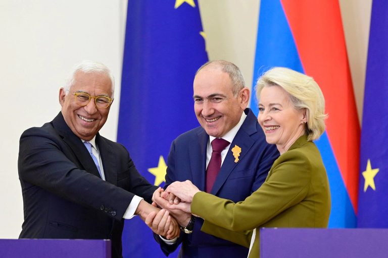 Prime Minister Nikol Pashinyan of Armenia joining hands with EU officials.