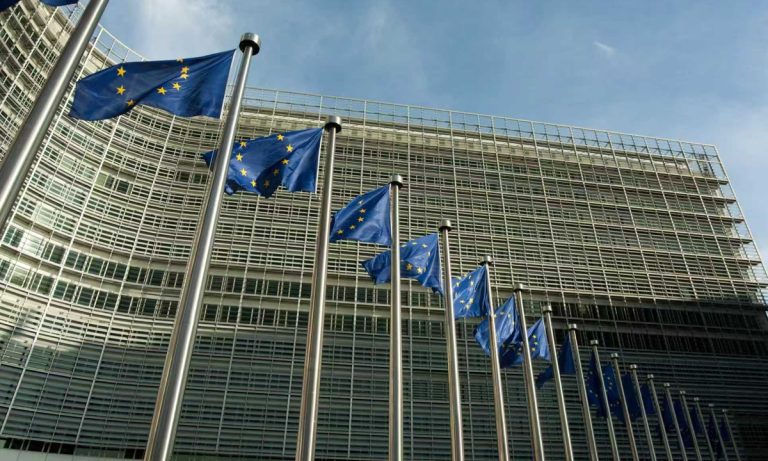 European Union flags flying outside the European Commission building in Brussels.