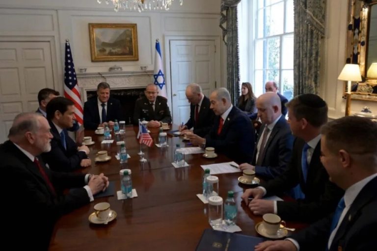 US and Israeli officials sitting around a conference table during a high-level diplomatic meeting.