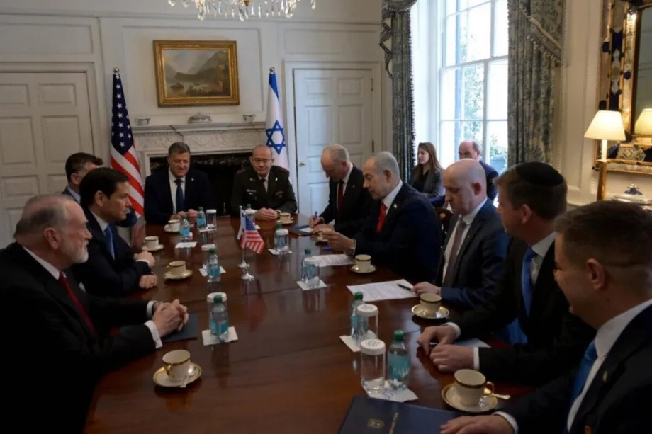 US and Israeli officials sitting around a conference table during a high-level diplomatic meeting.