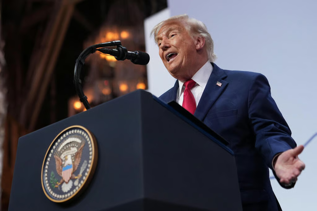 Donald Trump speaking at a podium with the U.S. Presidential Seal.