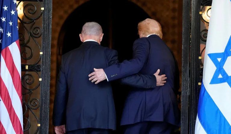 Former President Donald Trump and Benjamin Netanyahu seen from behind, standing between American and Israeli flags.