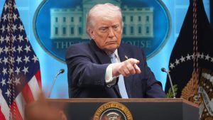 Donald Trump speaking at a podium in front of the White House seal.