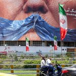 A large urban billboard in Iran displaying political imagery and flags with the Persian text "Breaking Point" at the Strait of Hormuz.