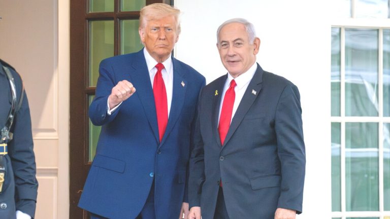 Donald Trump and Benjamin Netanyahu stand together in formal attire.