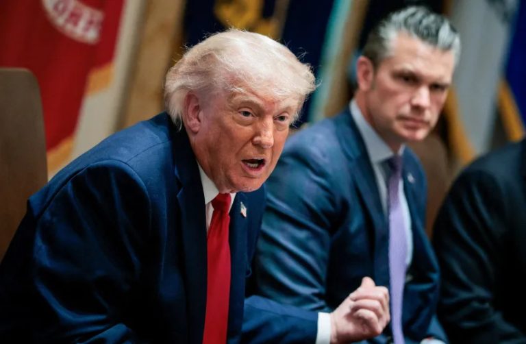 Donald Trump speaking at a conference with an associate nearby.